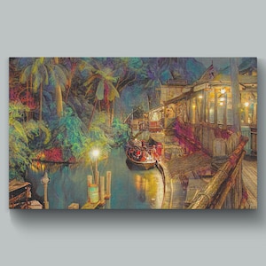 May include: A colorful canvas print depicts a tropical scene with a boat on a waterway, lush foliage, and buildings with warm lighting. The artwork evokes a sense of adventure and exotic locales.
