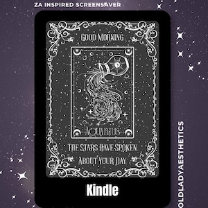 May include: A black Kindle e-reader displaying a white graphic of the Aquarius zodiac sign, featuring a water pitcher pouring water, surrounded by stars and ornate borders. Text reads: DIGITAL DOWNLOAD, ZA INSPIRED SCREENSAVER, GOOD MORNING, AQUARIUS, THE STARS HAVE SPOKEN ABOUT YOUR DAY, KINDLE, OLDLADYAESTHETICS.