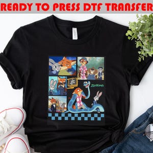 May include: Black t-shirt featuring a colorful collage of characters from the animated movie "Zootopia." The design includes images of a fox, a rabbit, and other characters, with the word "Zootopia" in green. The text "READY TO PRESS DTF TRANSFER" is at the top.
