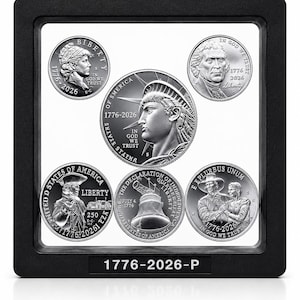 May include: A black square display frame containing five silver-toned commemorative coins. The coins feature historical American imagery, including the Statue of Liberty, the Liberty Bell, and portraits, with the text 1776-2026-P on the frame base.