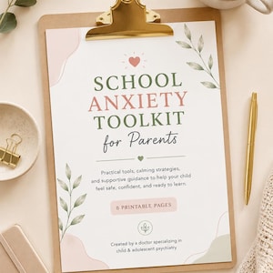 May include: A clipboard with a printed document titled "SCHOOL ANXIETY TOOLKIT for Parents." The document includes text about practical tools and calming strategies. A gold pen and a cup of coffee are also visible.