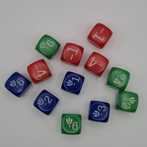 May include: An assortment of twelve multi-sided dice in red, green, and blue. Each die features a number and a symbol. The dice are scattered across a white surface, with the numbers and symbols in white.