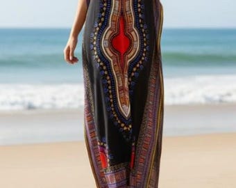 May include: A floor-length black kaftan dress featuring a central vertical pattern in red, blue, yellow, and white. The garment has short sleeves, a round neckline with a small button placket, and side slits that extend from the hem to the mid-thigh.