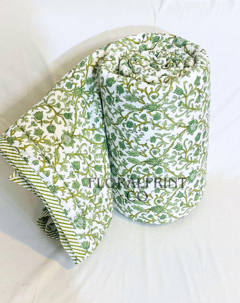 Artisan cotton quilt with floral block print design and reversible styling for added versatility. Crafted to be soft, breathable, and lightweight, it keeps you comfortable without feeling heavy. Ideal for bedroom décor, couch lounging, guest bedding, or reading corners. This handmade all season blanket combines everyday function with beautiful traditional textile artistry.