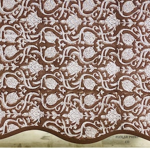 Handmade Mud Brown floral tablecloth crafted using traditional Indian block printing techniques and styled on a rectangular wooden dining table. The reusable cotton table linen with matching piping creates a timeless farmhouse and boho aesthetic perfect for entertaining guests, holiday celebrations, wedding receptions, kitchen décor, and stylish family dining experiences.