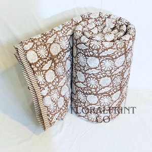 Soft cotton comforter blanket with floral hand block print details and double-sided reversible beauty. Lightweight design is easy to fold, store, and use throughout the year. Perfect for beds, couches, nursery rooms, or relaxing afternoons. This handmade quilt adds texture, warmth, and color while celebrating traditional artisan craftsmanship in your home décor.