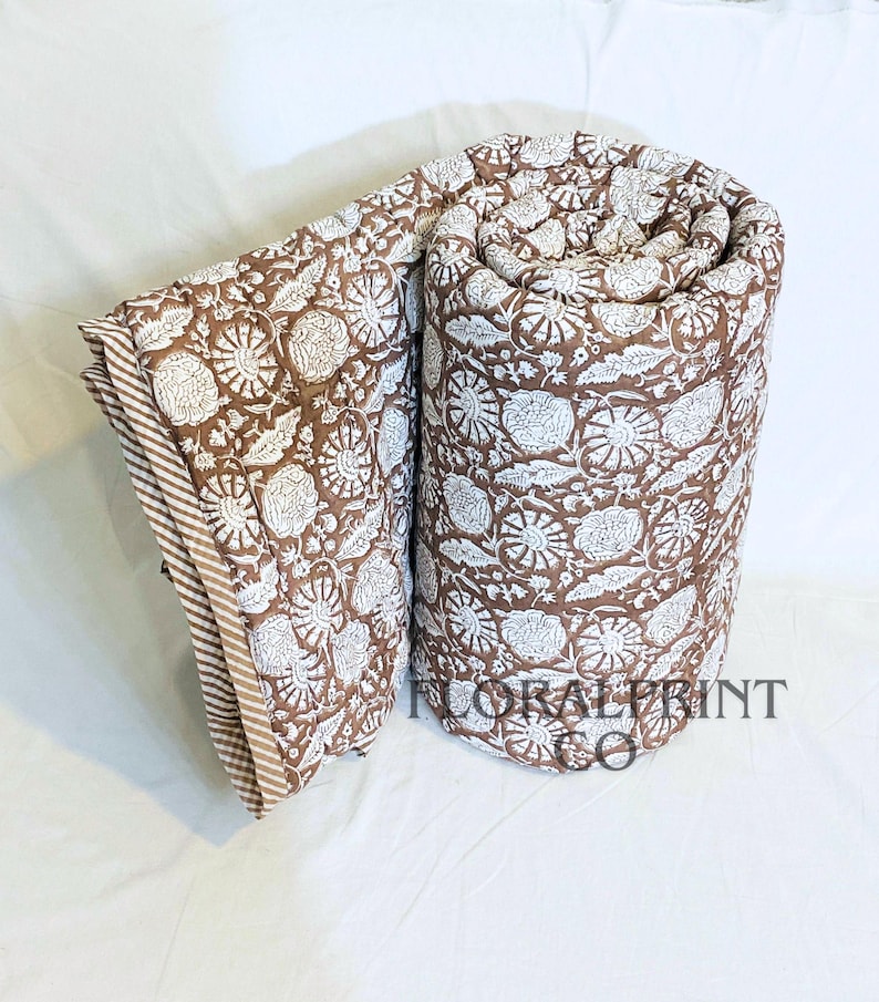 Soft cotton comforter blanket with floral hand block print details and double-sided reversible beauty. Lightweight design is easy to fold, store, and use throughout the year. Perfect for beds, couches, nursery rooms, or relaxing afternoons. This handmade quilt adds texture, warmth, and color while celebrating traditional artisan craftsmanship in your home décor.