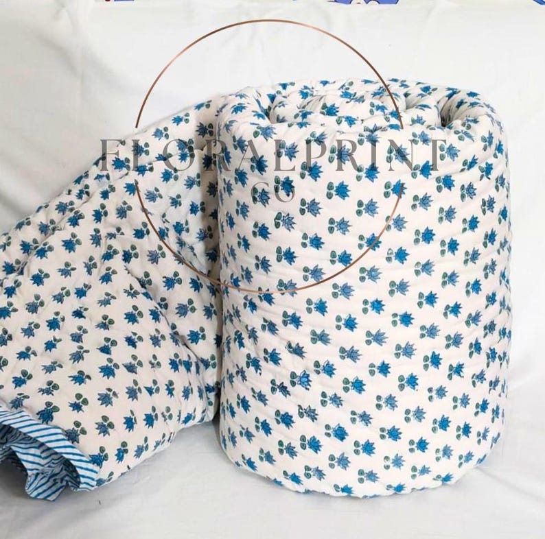 Cotton handmade quilt with floral block printed patterns on both sides, offering a reversible bedspread style for versatile décor. Soft and airy construction makes it ideal for spring, summer, autumn, and mild winter layering. Perfect for bedrooms, couch naps, guest rooms, or travel stays. A charming handcrafted blanket that brings warmth and artisan beauty to your home.