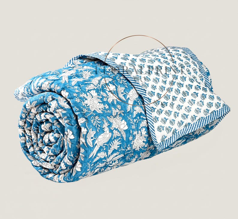 Handmade cotton block printed quilt featuring beautiful floral patterns and a reversible design for two stylish looks in one. Soft, lightweight, and comfortable for year-round use on your bed, couch, or guest room. This artisan quilt adds warmth, color, and handcrafted charm to any space while offering breathable comfort for every season. Perfect for layering or using as a decorative bedspread.