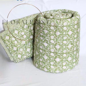 Soft lightweight comforter blanket crafted from cotton and decorated with hand block printed floral motifs. Reversible design lets you refresh your room instantly with two lovely sides. Suitable for beds, couches, picnic use, or cozy evenings indoors. Breathable and comfortable through every season, this handmade quilt is a thoughtful housewarming or wedding gift.