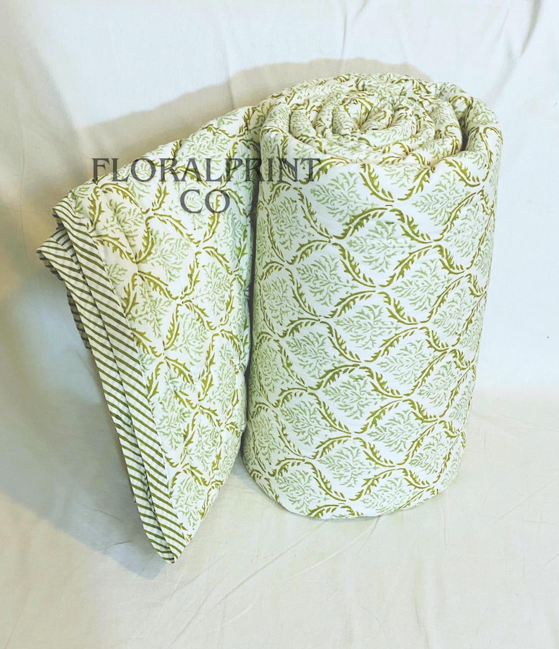 Beautiful reversible bedspread made from cotton with hand block printed floral artwork. Soft texture and lightweight feel make this comforter blanket easy to use in all seasons. Drape it across your king, queen, or twin bed, or keep it on the sofa for extra comfort. Handmade craftsmanship gives each quilt unique character and timeless appeal.