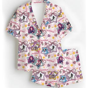 May include: Pink pajama set with a repeating pattern of cartoon characters, stars, and bows. The set includes a short-sleeved button-up shirt and matching shorts. The text "HUNTRAX" is visible throughout the design.