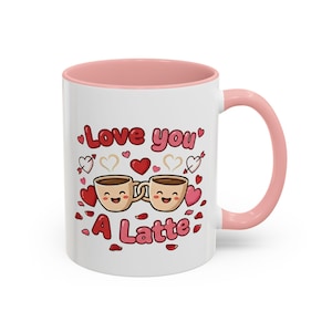 May include: White ceramic mug with a pink interior and handle. The mug features the text "Love you a Latte" with cartoon coffee cups, hearts, and arrows. The design is in red, pink, and brown.