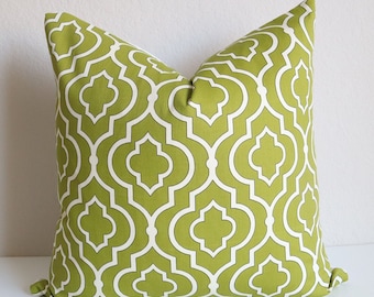 May include: Green and white geometric patterned throw pillow with a square shape.