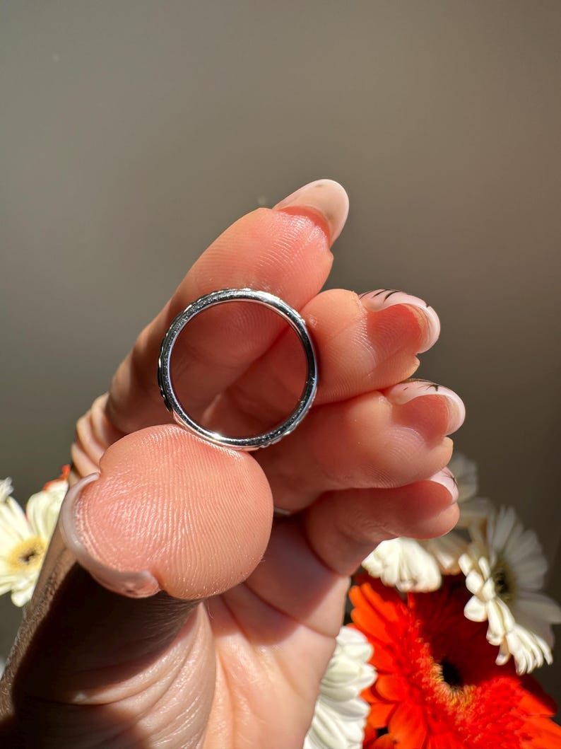 May include: A set of three ceramic mugs with a speckled, matte finish. The mugs are in shades of cream, light brown, and dark brown. Each mug has a simple, minimalist design and a rounded handle.
