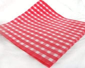 May include: Red and white checkered paper, folded in half, with a white background.