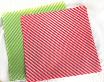 May include: Two sheets of wrapping paper, one green and one red, with white diagonal stripes.