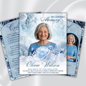 May include: A memorial card design featuring a portrait of an older woman, surrounded by blue roses and doves. The card includes the text "In Loving Memory" and details about Olivia Willson's life and memorial service.