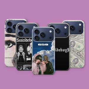 May include: A collection of five phone cases with various designs. The cases feature images of a person's eye, the text "Suicideboys", a cloudy sky with two people, the text "$uicideboy$", and a pattern of dollar bills. The cases are on a purple background.