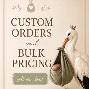 May include: A white stork wearing a small gold crown carries a sage green fabric bundle containing a baby. The text reads CUSTOM ORDERS and BULK PRICING At checkout. The design features a beige background with decorative line borders and icons.