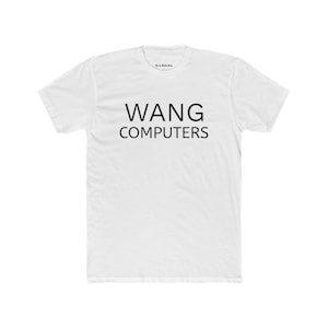 May include: White t-shirt with the text "WANG COMPUTERS" in black, centered on the front. The word "ILLEGAL" is printed in small black letters near the collar.