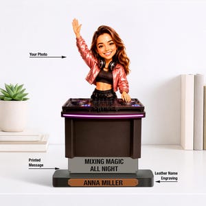 May include: A custom bobblehead figurine of a DJ with long brown hair, wearing a metallic pink jacket and black top, standing behind a black DJ controller console. The base features the printed text MIXING MAGIC ALL NIGHT and a leather name tag ANNA MILLER.