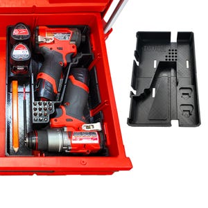 May include: A red toolbox with power tools and accessories. The toolbox contains a drill, impact driver, batteries, and a black plastic organizer with the text "TidyTool". The tools are black and red.