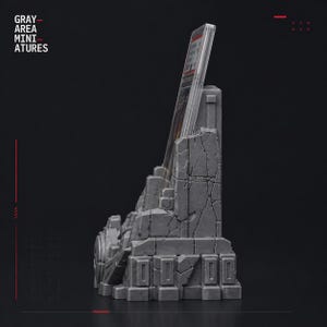 May include: A gray miniature display stand with a weathered, stone-like appearance. The stand is designed to hold a card or other item, with the text "GRAY AREA MINIATURES" visible on the left side. The stand has a detailed, textured surface.