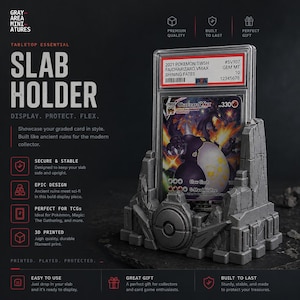 May include: A gray 3D-printed slab holder designed to display and protect graded cards. The holder has an ancient ruins design and features the text "SLAB HOLDER". A Pok&eacute;mon card is displayed in the holder.
