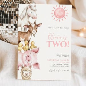 May include: A light pink invitation card with watercolor illustrations of farm animals, including a horse, goat, ducks, pig, and llama. The text "Olivia is TWO!" is in pink, with event details below.
