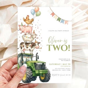 May include: A birthday invitation card featuring a green tractor topped with a stack of farm animals including a cow, sheep, pig, and chicken wearing party hats. The text reads: Calling all party animals! Oliver is TWO! Saturday May 14.