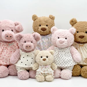 May include: A collection of plush toys, including pink pigs and teddy bears, all wearing pajamas. The pigs have pink fur and pig snouts. The bears are brown and pink, with soft, cuddly fur. The pajamas have various patterns.