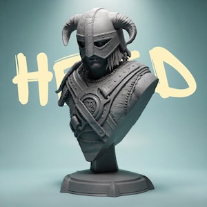May include: A grey monochromatic bust of a warrior wearing a horned helmet and detailed chest armor with straps and a circular emblem. The figure has long hair and a visible face mask. The text "HERO" is written in large, light yellow letters behind.