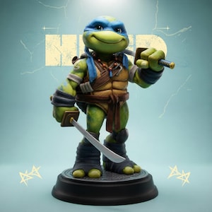 May include: A figurine of Leonardo, a Teenage Mutant Ninja Turtle, stands on a round black base. The figure is green with a blue mask, holding two katanas. He wears a brown belt, chest armor, and wrist and ankle wraps. The background is a light blue with a faded yellow graphic.