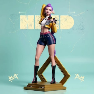 May include: A figurine of a woman with purple hair, wearing a yellow jacket, white crop top, and blue shorts. She holds a microphone and stands on a gold platform with a gold frame behind her. The background is a light teal color with the word "HIND" in a light yellow color.