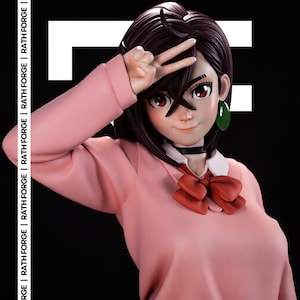 May include: A collectible anime-style figurine of a character with dark brown hair, red eyes, and a green earring. The figure wears a pink long-sleeved top with a white collar and a red bow tie. The text RATH FORGE is printed vertically on the left side.