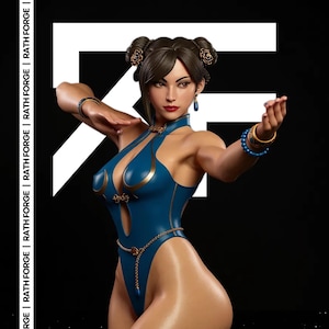 May include: A detailed figurine of a woman in a blue and gold bodysuit, with her hair styled in buns. She is wearing gold and blue jewelry. The background is black with white geometric shapes and the text "RATH FORGE".