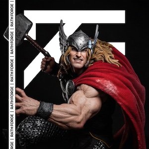 May include: A detailed image of a Thor statue, holding a hammer. The statue features a silver helmet with wings, a red cape, and long blonde hair. The text "RATH FORGE" is visible on the left side.