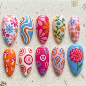 May include: A set of ten almond-shaped, press-on nails with colorful, groovy designs. The designs include flowers, swirls, mushrooms, peace signs, and paisley patterns in shades of pink, orange, blue, and white.