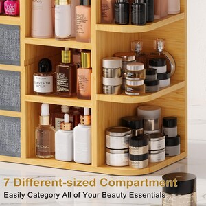 May include: A light-colored wooden cosmetic organizer featuring multiple shelves and drawers filled with various skincare and beauty products, including bottles, jars, and nail polish. The text 7 Different-sized Compartment Easily Category All of Your Beauty Essentials is visible.