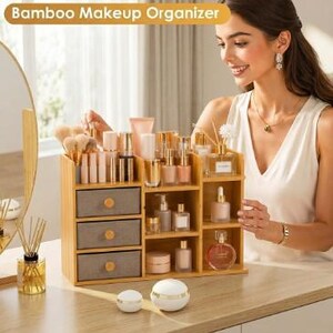 May include: A bamboo makeup organizer featuring three gray fabric drawers with round wooden knobs, multiple open shelves, and various compartments for storing cosmetics, brushes, and skincare bottles, labeled Bamboo Makeup Organizer.