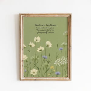 May include: Framed art print featuring a green background with white and purple wildflowers. The print includes the text "Medicate, Meditate, Swear your soul to Jesus, Throw a punch, fall in love, Give yourself a reason."