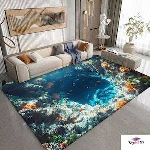 Puede incluir: Una alfombra rectangular con una vibrante escena submarina que presenta arrecifes de coral, peces y un abismo azul profundo. El diseño de la alfombra incorpora tonos de azul, naranja y verde, creando un efecto realista de fondo marino.