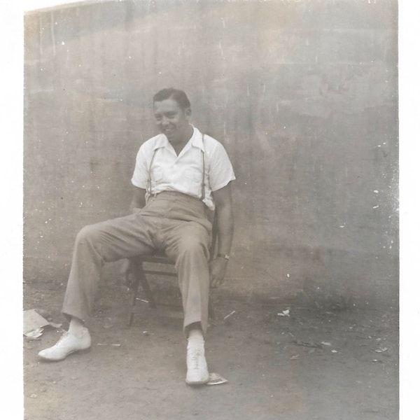 Smiling Young Man Sitting With Legs Relaxed Suspenders White Shoes Vintage Black & White Snapshot Photo
