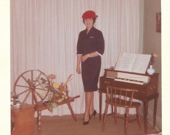 Airline Attendant Stewardess Vintage Color Photo Lovely Young Woman Wearing Uniform Posing At Home With Spinet & Spinning Wheel