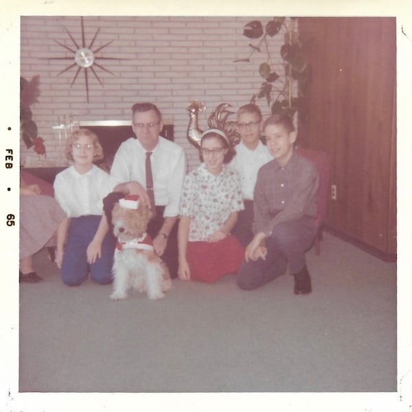 Family Dog Wears Santa Claus Costume Vintage Color Photo Dad & Kids Pose WithTerrier Dog Wearing Christmas Outfit 1960’s Snapshot