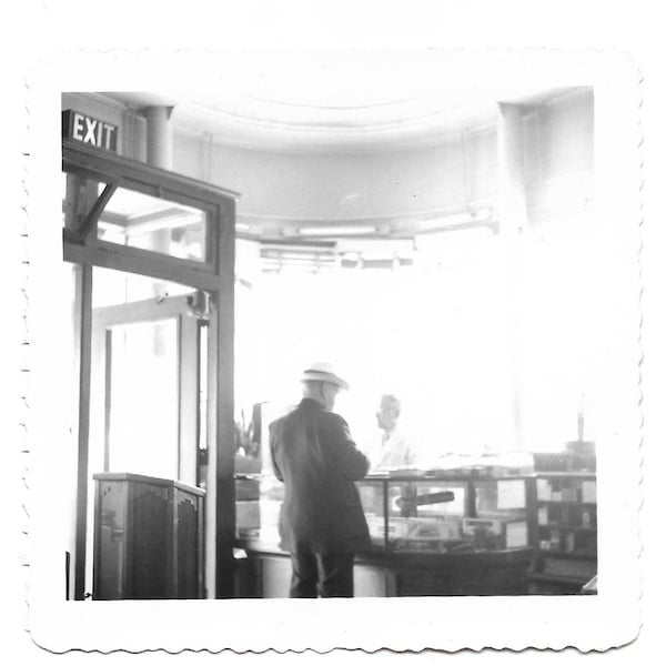 Man Buying A Cigar Vintage Photo Fedora Hat Man At Glass-Fronted Display Case Cigar Boxes Store Clerk Exit Sign Incongruous Wooden Pulpit