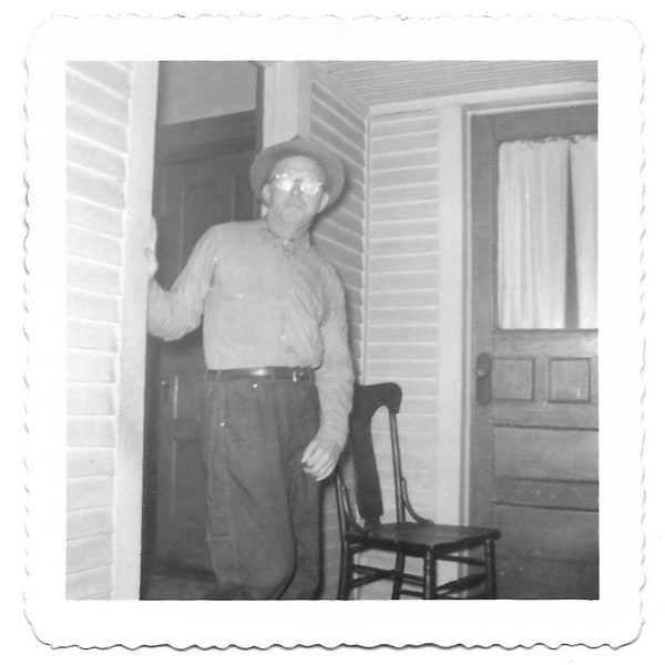 Flash Reflection In His Eyeglasses Vintage Photo Man Wearing Hat Poses For Photo But Flash Creates Glare On Glasses 1960’s Snapshot