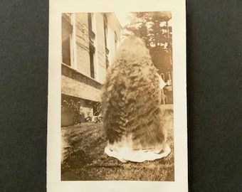 Creepy Vintage Photo Puddle Of Clothes Topped By Wavy Long Hair Back To Camera Sepia Photograph