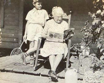 Vintage Photo Grandmother Reading Magazine Tennis Racket Boy Looks Over Her Shoulder